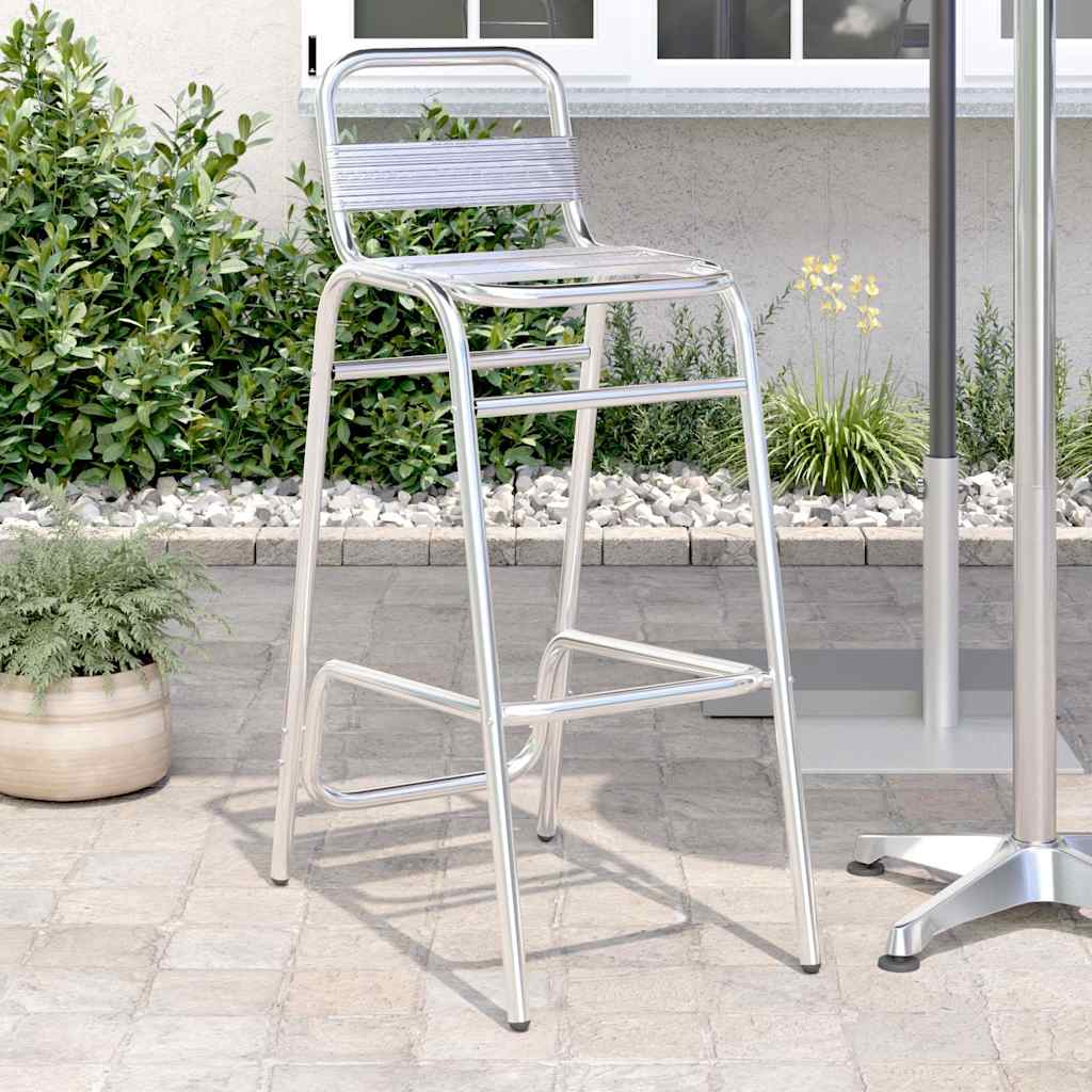 Silver aluminium stackable bar stool with woven seat, side view outdoors.