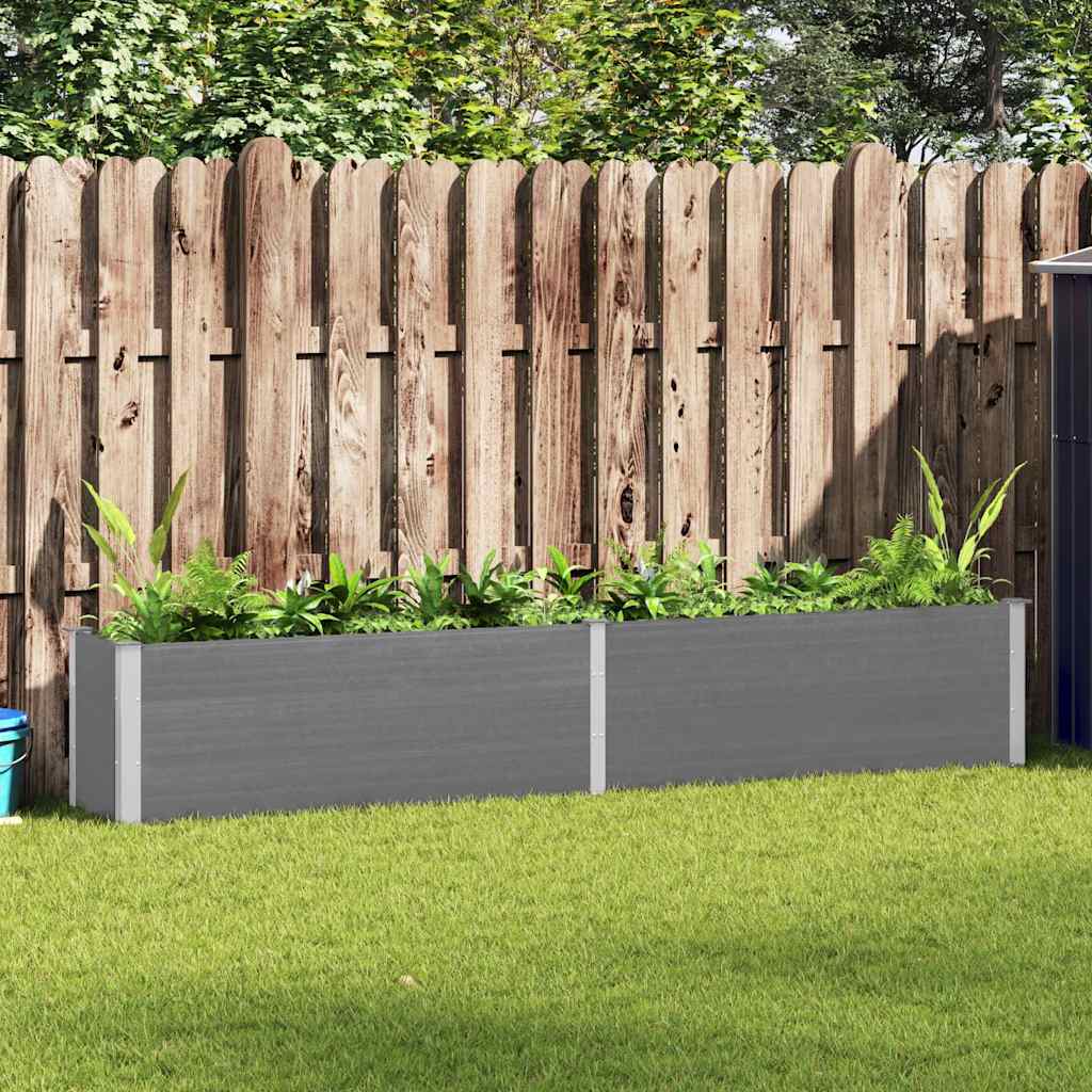 Large grey raised garden bed with wood-plastic composite panels and metal supports, set against a wooden fence.