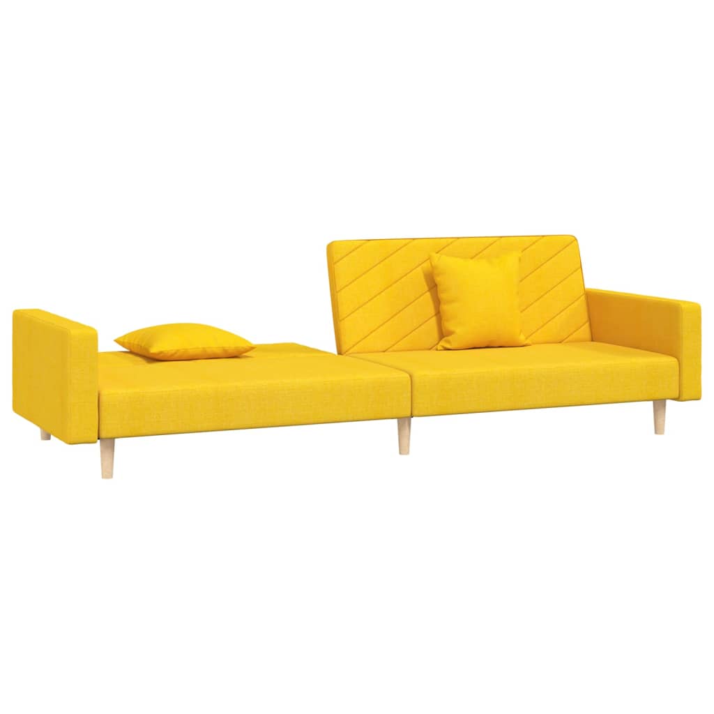 Kétszemélyes sárga szövet kanapéágy két párnával 