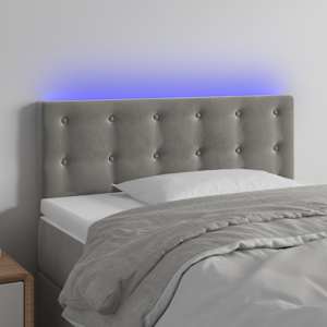 Čelo postele s LED světle šedé 90x5x78/88 cm samet