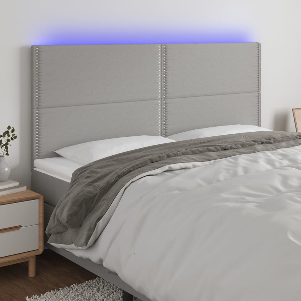 Čelo postele s LED světle šedé 160x5x118/128 cm textil