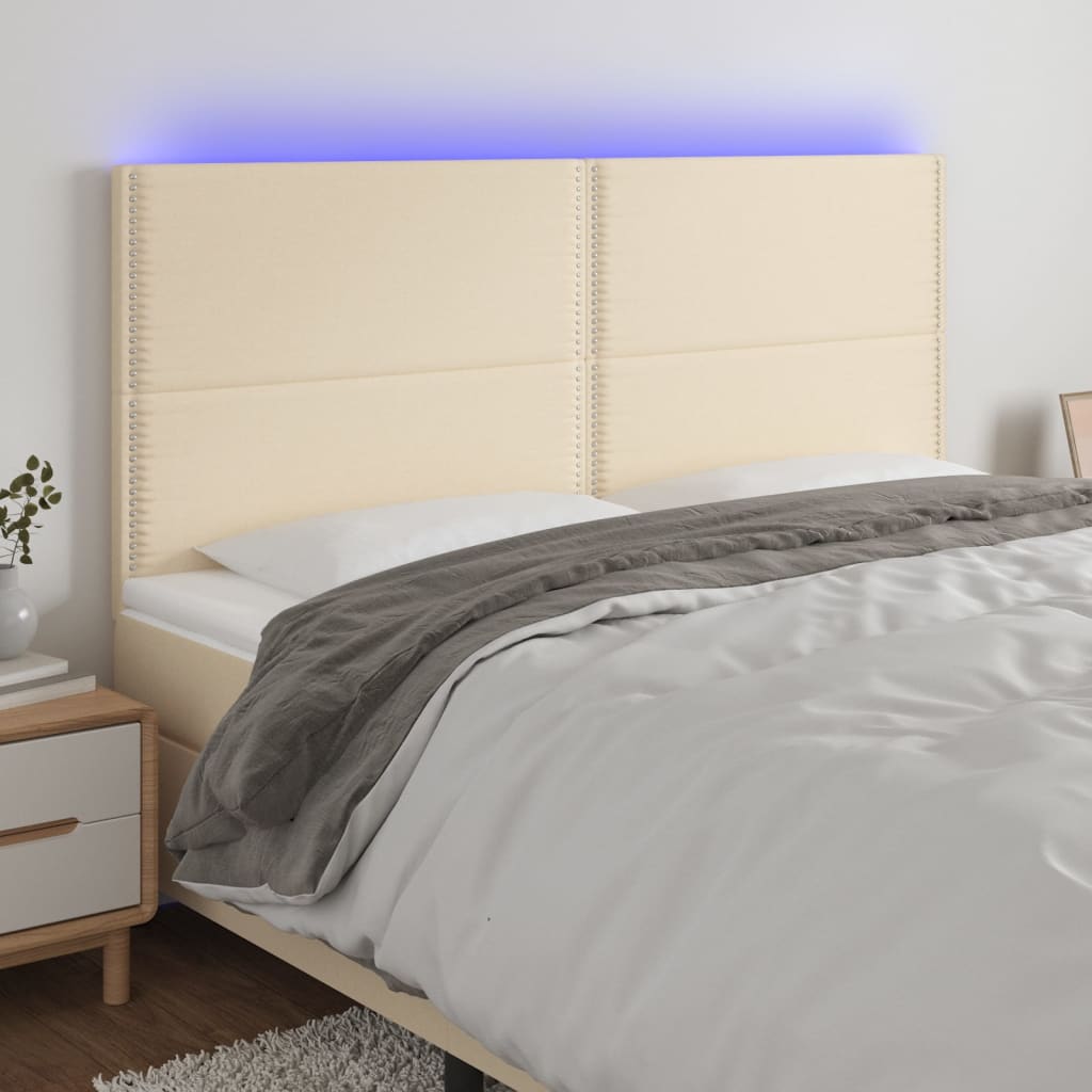 Čelo postele s LED krémové 160x5x118/128 cm textil