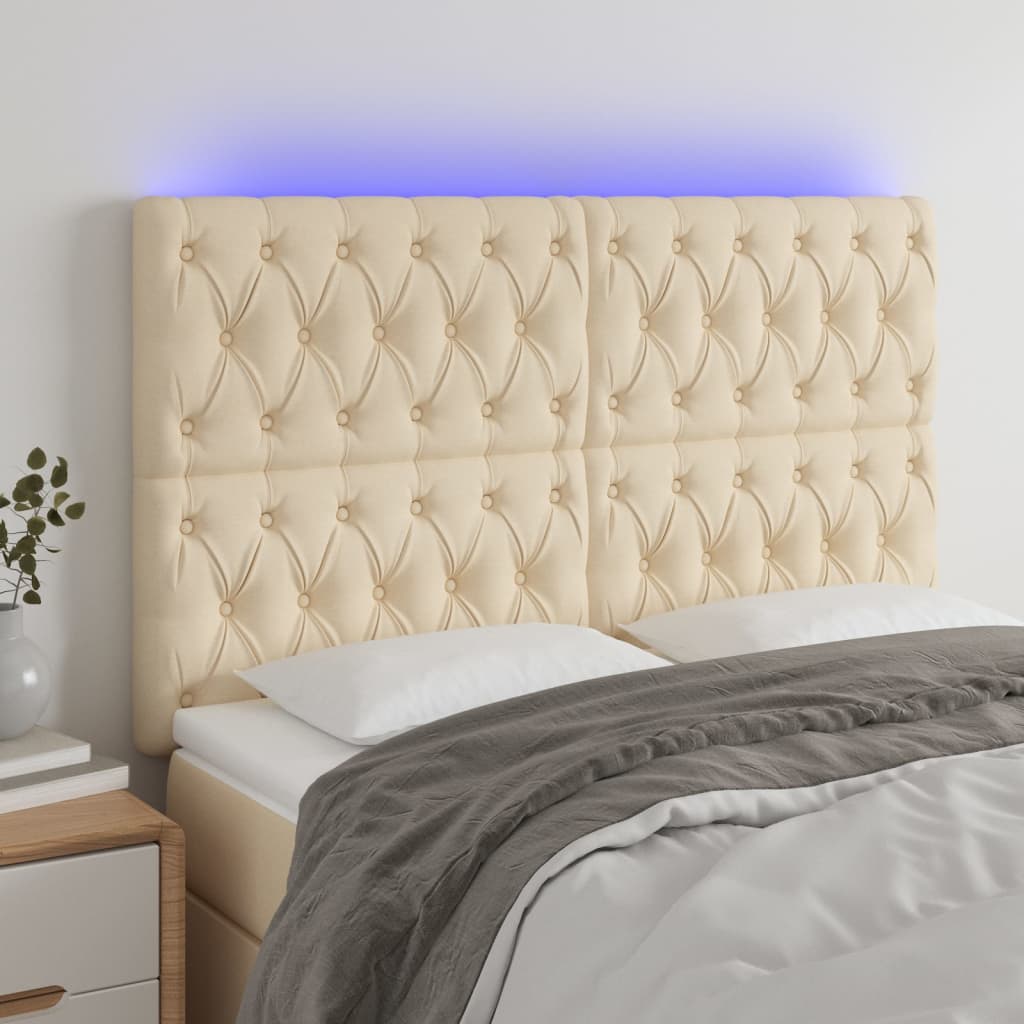 Čelo postele s LED krémové 160x7x118/128 cm textil