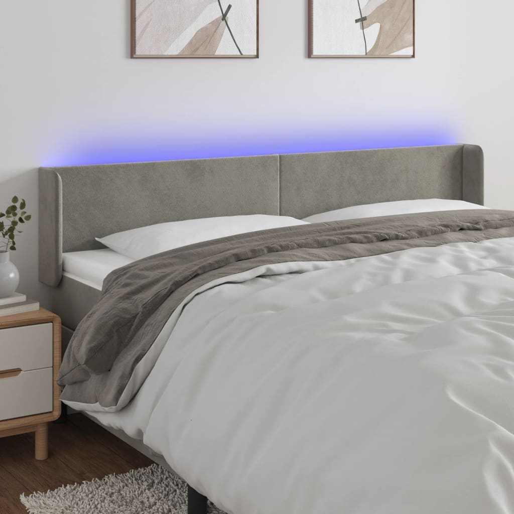 Čelo postele s LED světle šedé 163 x 16 x 78/88 cm samet