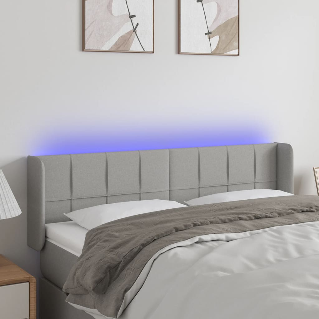 Čelo postele s LED světle šedé 147 x 16 x 78/88 cm textil