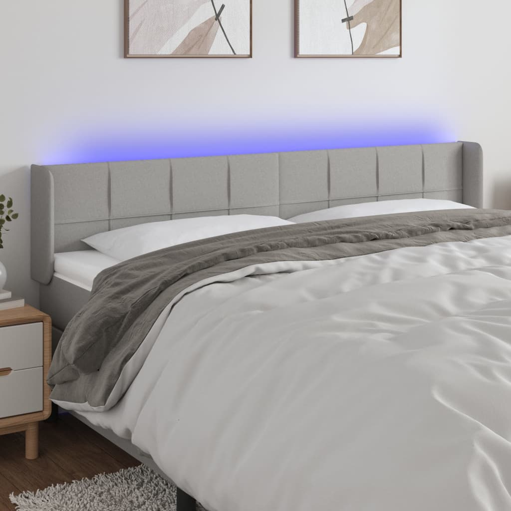 Čelo postele s LED světle šedé 183 x 16 x 78/88 cm textil