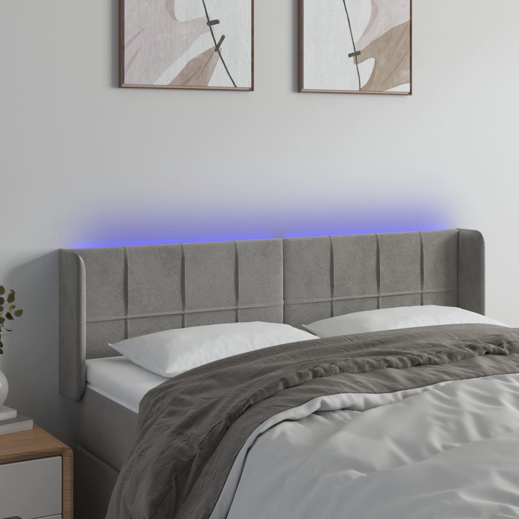 Čelo postele s LED světle šedé 147 x 16 x 78/88 cm samet