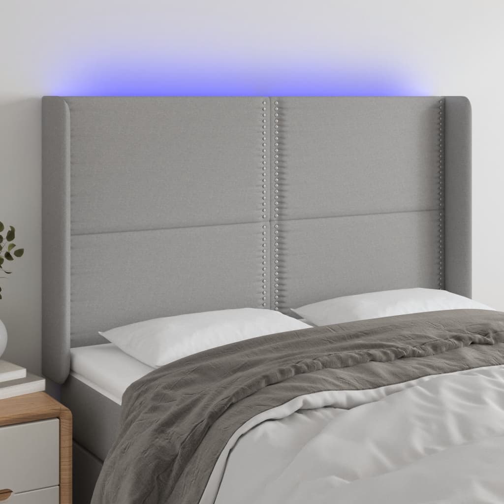 Čelo postele s LED světle šedé 147x16x118/128 cm textil