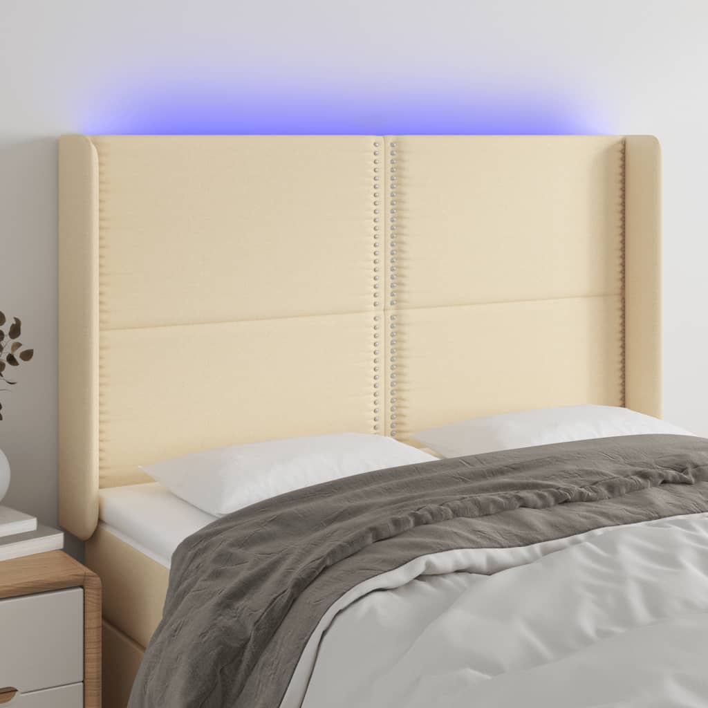 Čelo postele s LED krémové 147 x 16 x 118/128 cm textil