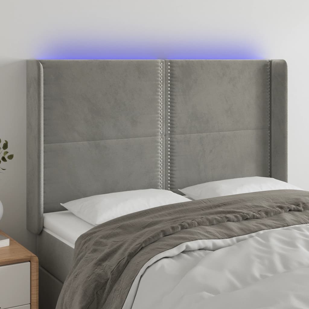 Čelo postele s LED světle šedé 147x16x118/128 cm samet