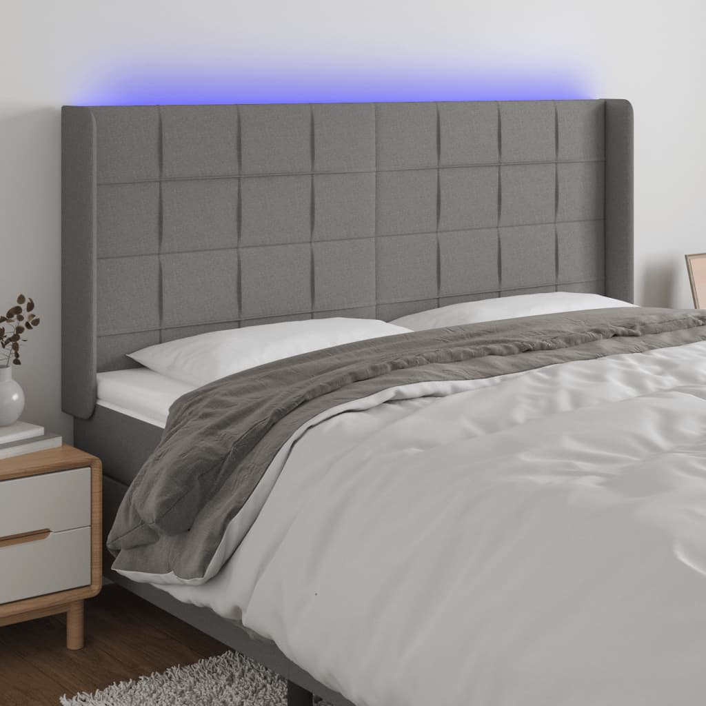 Čelo postele s LED tmavě šedé 163 x 16 x 118/128 cm textil