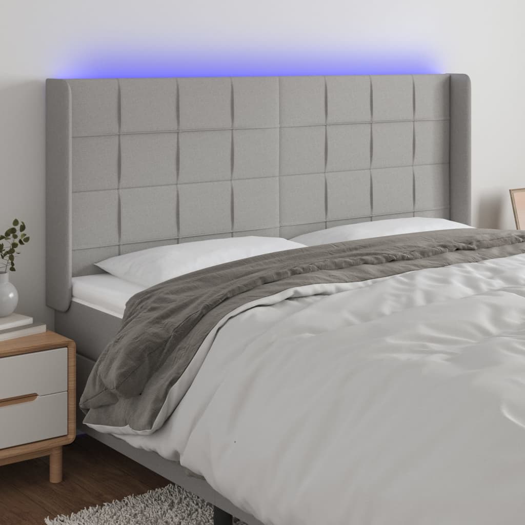 Čelo postele s LED světle šedé 183x16x118/128 cm textil