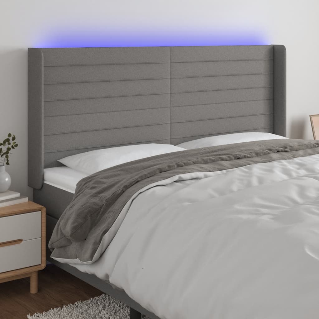 Čelo postele s LED tmavě šedé 163 x 16 x 118/128 cm textil