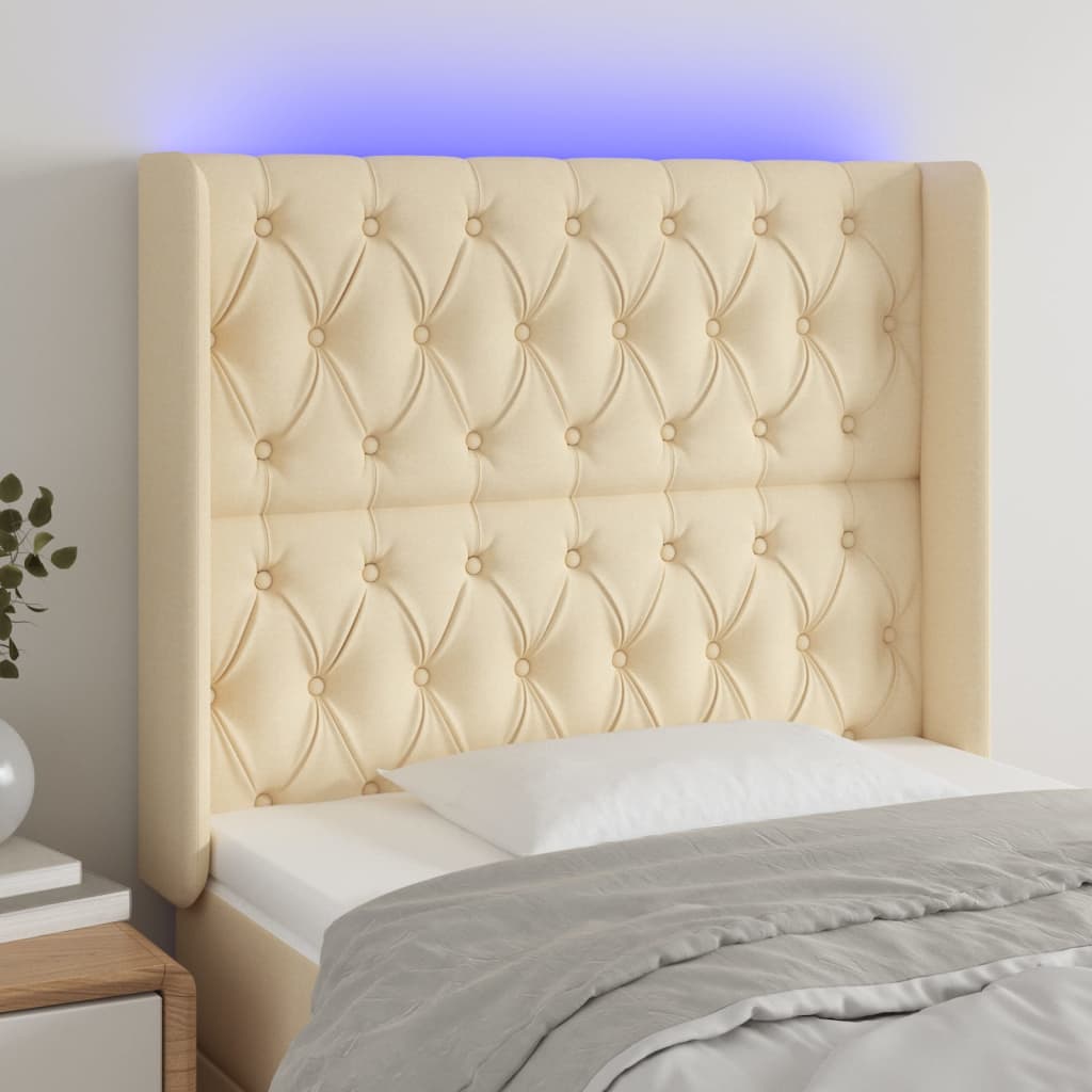Čelo postele s LED krémové 103 x 16 x 118/128 cm textil