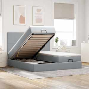 Otomanski posteljni okvir z vzmetnicami siv 180x200 cm blago